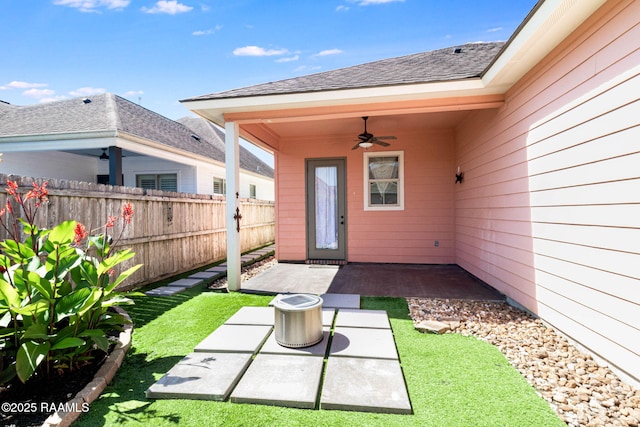 123 Laurel Grove Blvd, Youngsville, LA 70592 - property entrance featuring fence, a patio area, a ceiling fan, and roof with shingles