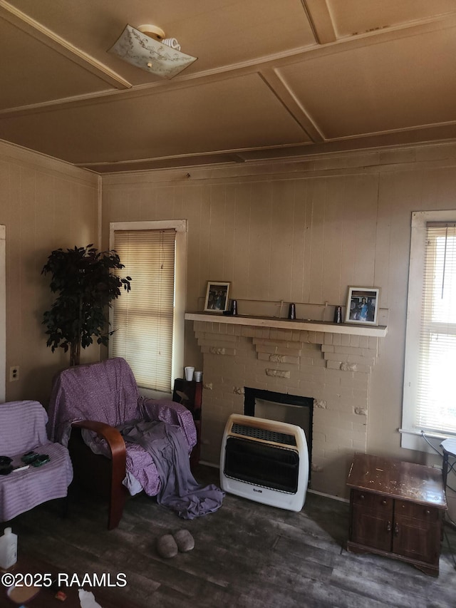 713 E Vermilion St, Lafayette, LA 70501 - living room featuring heating unit, wood finished floors, a fireplace, and wooden walls