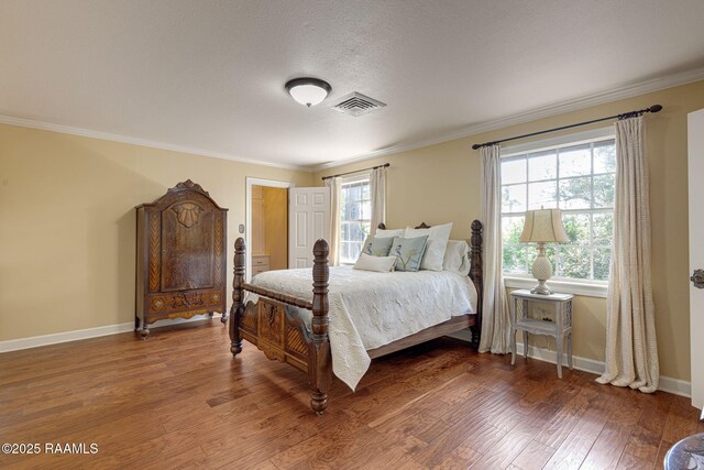 207 Beverly Dr, Lafayette, LA 70503 - bedroom featuring wood finished floors, baseboards, crown molding, and a textured ceiling