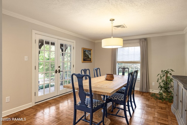 207 Beverly Dr, Lafayette, LA 70503 - dining space featuring french doors, healthy amount of natural light, baseboards, crown molding, and a textured ceiling