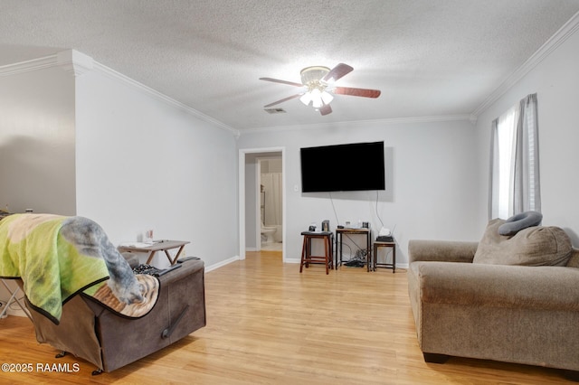 114 Marina Loop, Scott, LA 70583 - living area featuring light wood-style flooring, ornamental molding, a textured ceiling, a ceiling fan, and baseboards