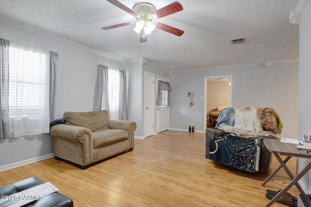 114 Marina Loop, Scott, LA 70583 - living area with ceiling fan, ornamental molding, a textured ceiling, light wood-style floors, and baseboards