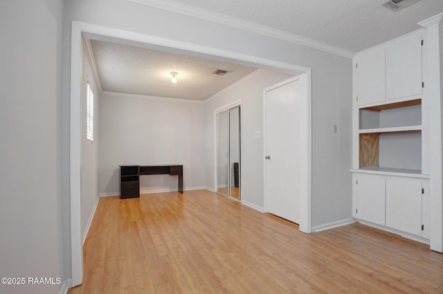 114 Marina Loop, Scott, LA 70583 - empty room with a textured ceiling, light wood finished floors, ornamental molding, and baseboards