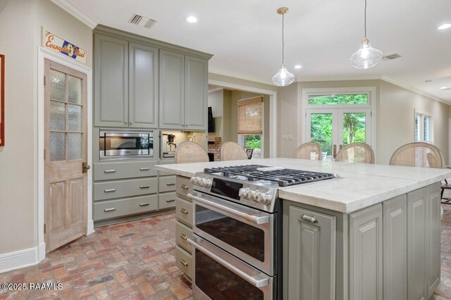 kitchen with stainless steel appliances, gray cabinetry, brick floors, crown molding, and hanging light fixtures