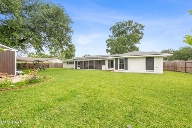 436 Brentwood Blvd, Lafayette, LA 70503 - rear view of house with a playground, a sunroom, and brick siding