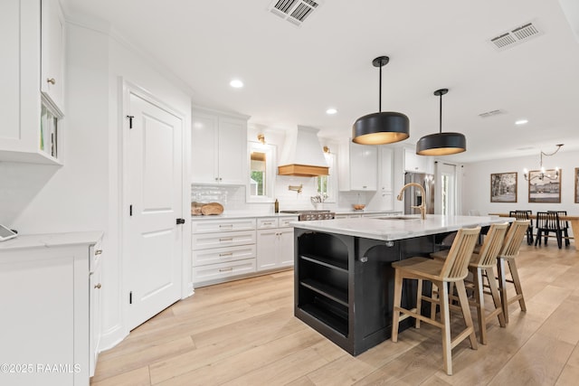 436 Brentwood Blvd, Lafayette, LA 70503 - kitchen with custom exhaust hood, white cabinetry, backsplash, open shelves, and recessed lighting