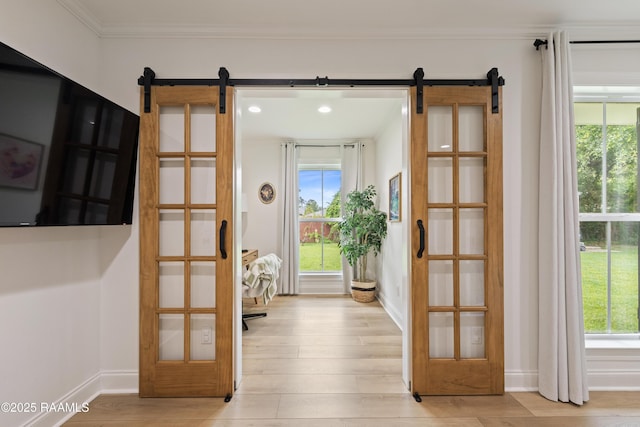 436 Brentwood Blvd, Lafayette, LA 70503 - doorway with a barn door, light wood finished floors, plenty of natural light, ornamental molding, and recessed lighting