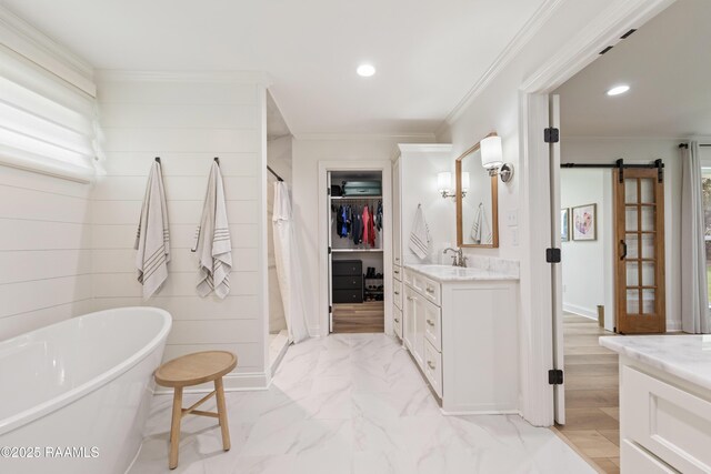 436 Brentwood Blvd, Lafayette, LA 70503 - full bathroom with vanity, a soaking tub, recessed lighting, ornamental molding, and a walk in closet