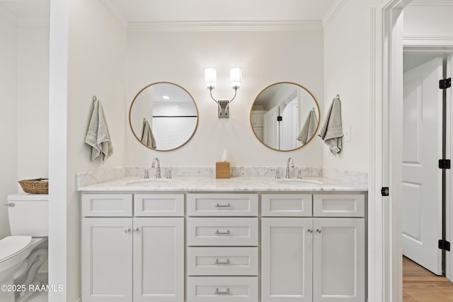 436 Brentwood Blvd, Lafayette, LA 70503 - bathroom with crown molding, toilet, double vanity, and wood finished floors