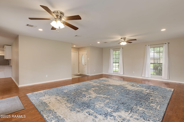 unfurnished living room with ceiling fan, baseboards, wood finished floors, and recessed lighting