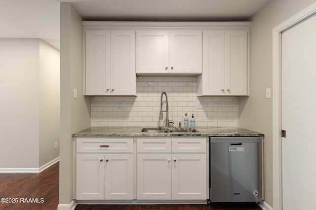 kitchen with stainless steel dishwasher, a sink, tasteful backsplash, and white cabinetry