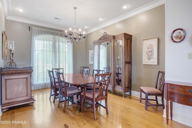 2311 Vida Shaw Rd, New Iberia, LA 70563 - dining area featuring light wood-style floors, a chandelier, crown molding, and baseboards