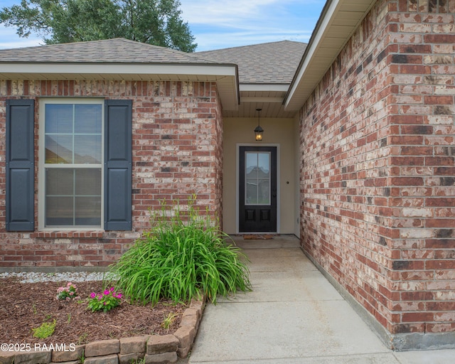 223 Moss Bluff Dr, Lafayette, LA 70507 - doorway to property featuring a shingled roof and brick siding