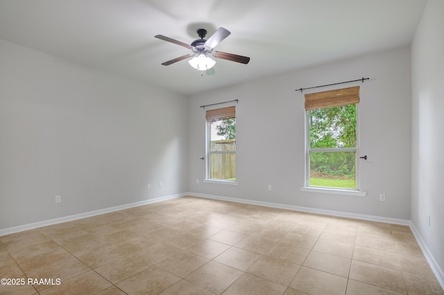 223 Moss Bluff Dr, Lafayette, LA 70507 - spare room with plenty of natural light, light tile patterned floors, ceiling fan, and baseboards