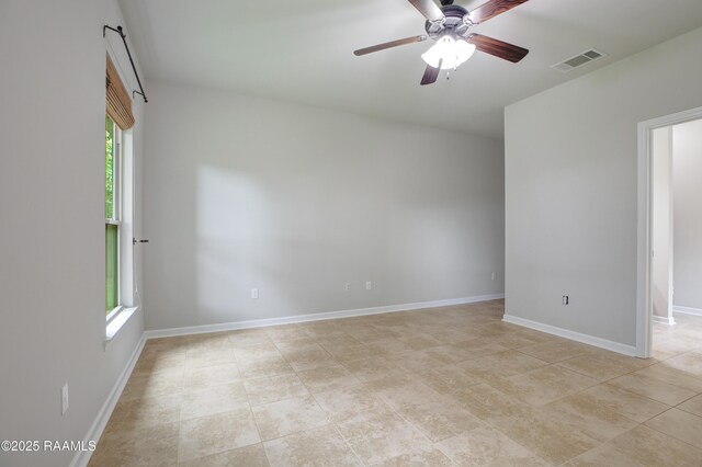 223 Moss Bluff Dr, Lafayette, LA 70507 - empty room with plenty of natural light, ceiling fan, baseboards, and light tile patterned floors