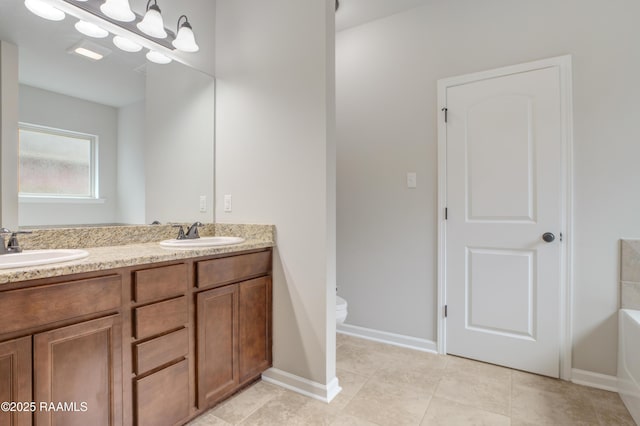 223 Moss Bluff Dr, Lafayette, LA 70507 - full bath with double vanity, toilet, baseboards, a tub to relax in, and tile patterned floors