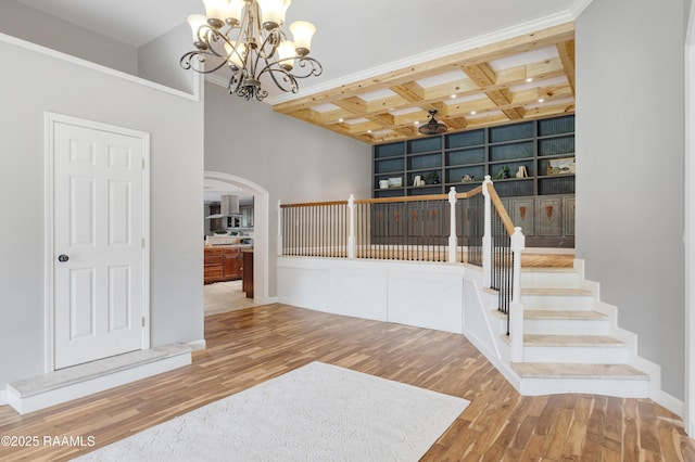 807 Cambridge Dr Res, Unit Res, Lafayette, LA 70503 - foyer entrance with a chandelier, arched walkways, wood finished floors, coffered ceiling, and beamed ceiling