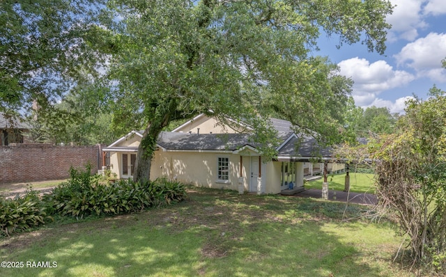 807 Cambridge Dr Res, Unit Res, Lafayette, LA 70503 - back of house featuring a yard and stucco siding
