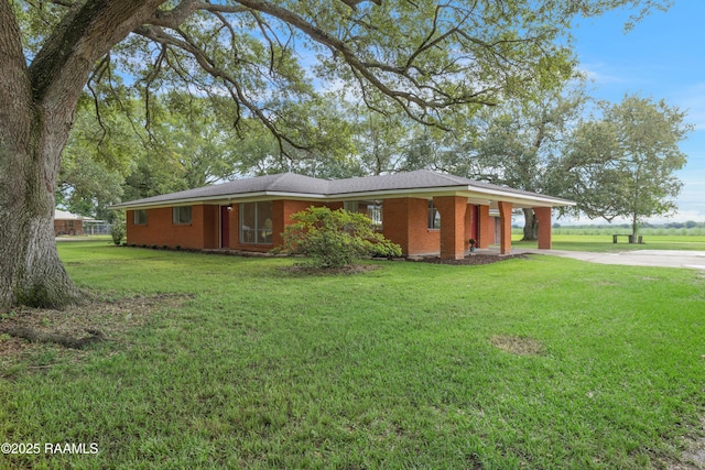 17639 Pelican Rd, Erath, LA 70533 - view of front of house featuring driveway, a front lawn, and brick siding