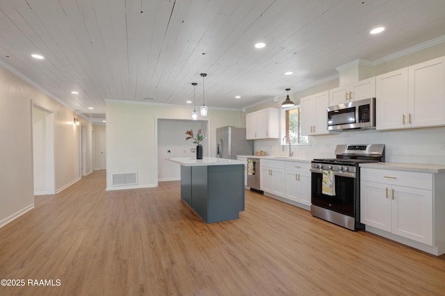 17639 Pelican Rd, Erath, LA 70533 - kitchen featuring stainless steel appliances, crown molding, a kitchen island, white cabinetry, and recessed lighting
