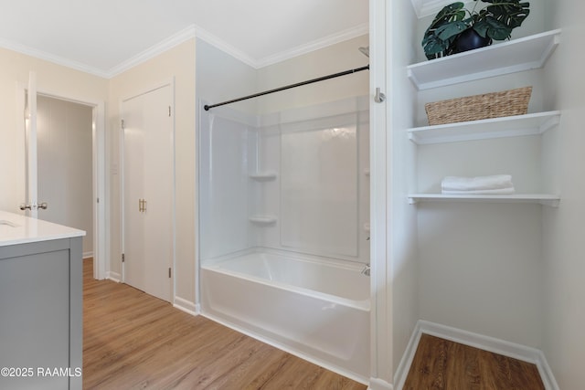 17639 Pelican Rd, Erath, LA 70533 - bathroom with wood finished floors, washtub / shower combination, vanity, baseboards, and ornamental molding