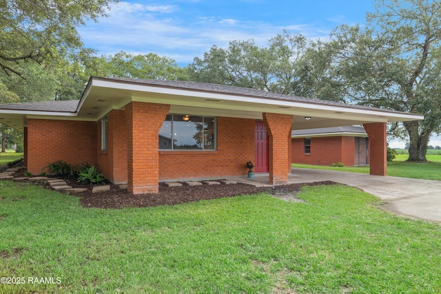 17639 Pelican Rd, Erath, LA 70533 - view of front of house with a front yard, concrete driveway, brick siding, and an attached carport