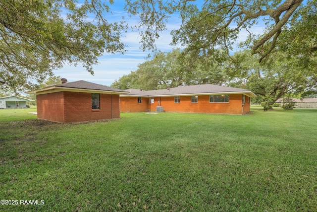 17639 Pelican Rd, Erath, LA 70533 - back of house with a lawn, central AC, and brick siding