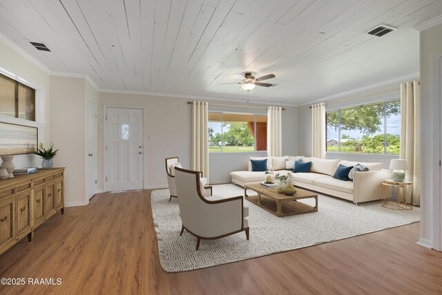 17639 Pelican Rd, Erath, LA 70533 - living area with wood finished floors, crown molding, ceiling fan, baseboards, and wooden ceiling