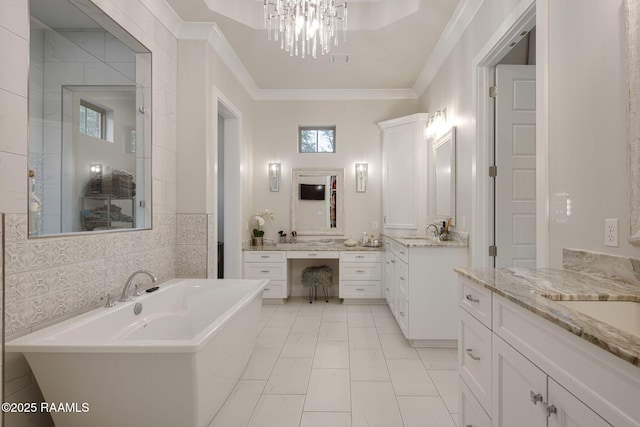 137 Grandview Terrace Dr, Youngsville, LA 70592 - bathroom featuring a freestanding bath, marble look tile flooring, plenty of natural light, two vanities, and ornamental molding