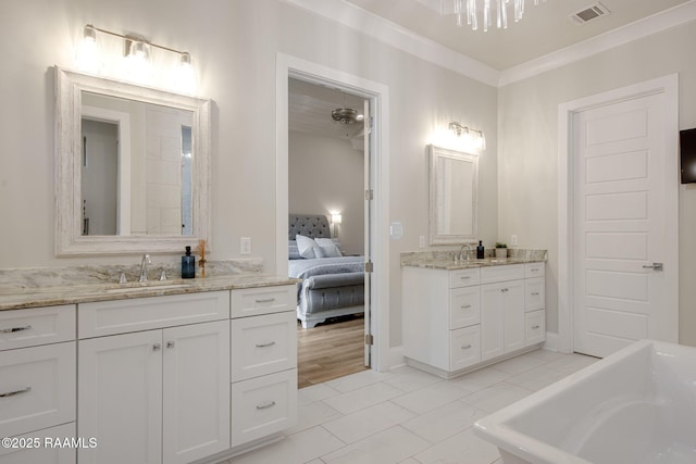 137 Grandview Terrace Dr, Youngsville, LA 70592 - ensuite bathroom with a bathtub, two vanities, and ornamental molding