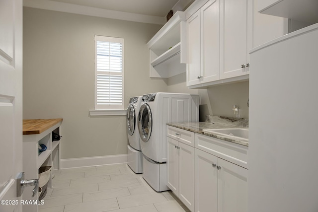 137 Grandview Terrace Dr, Youngsville, LA 70592 - laundry room featuring washer and clothes dryer, light marble finish floors, cabinet space, and baseboards