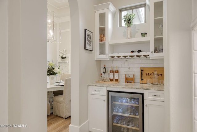 137 Grandview Terrace Dr, Youngsville, LA 70592 - indoor dry bar with wine cooler, tasteful backsplash, and light wood-style flooring