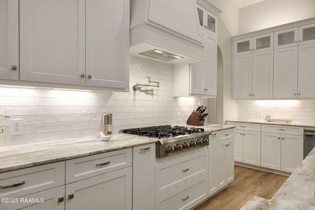 137 Grandview Terrace Dr, Youngsville, LA 70592 - kitchen with stainless steel gas cooktop, white cabinets, backsplash, and light stone counters