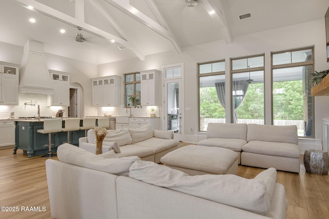 137 Grandview Terrace Dr, Youngsville, LA 70592 - living area featuring light wood-type flooring, high vaulted ceiling, beam ceiling, plenty of natural light, and recessed lighting