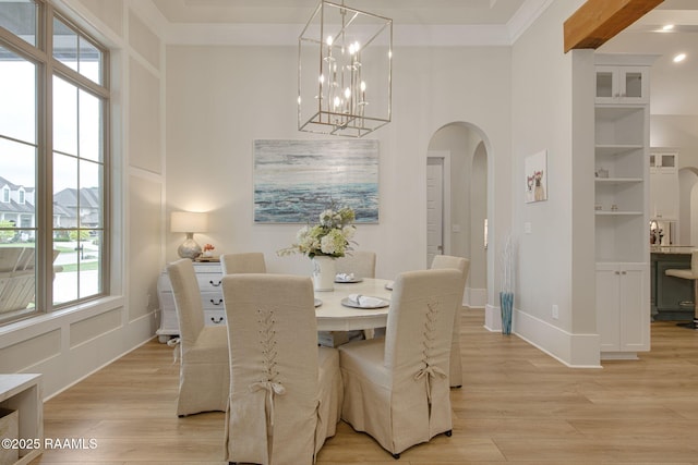 137 Grandview Terrace Dr, Youngsville, LA 70592 - dining room featuring arched walkways, crown molding, light wood-style floors, a high ceiling, and baseboards