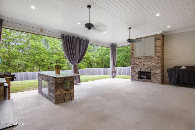137 Grandview Terrace Dr, Youngsville, LA 70592 - view of patio with an outdoor brick fireplace, a fenced backyard, and grilling area