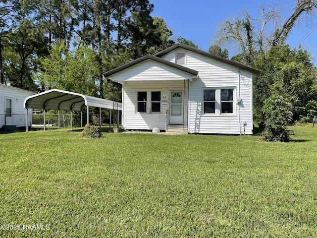 617 E Madison St, Opelousas, LA 70570 - rear view of house with entry steps, a yard, and a carport