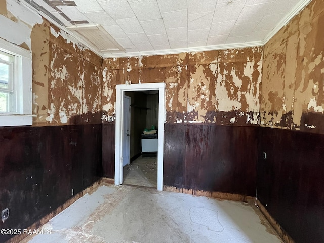 617 E Madison St, Opelousas, LA 70570 - unfurnished room featuring crown molding, unfinished concrete floors, and a wainscoted wall