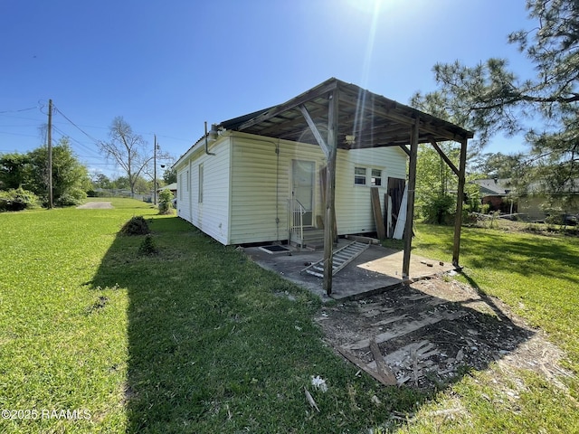 617 E Madison St, Opelousas, LA 70570 - back of property featuring entry steps, a yard, and a patio area