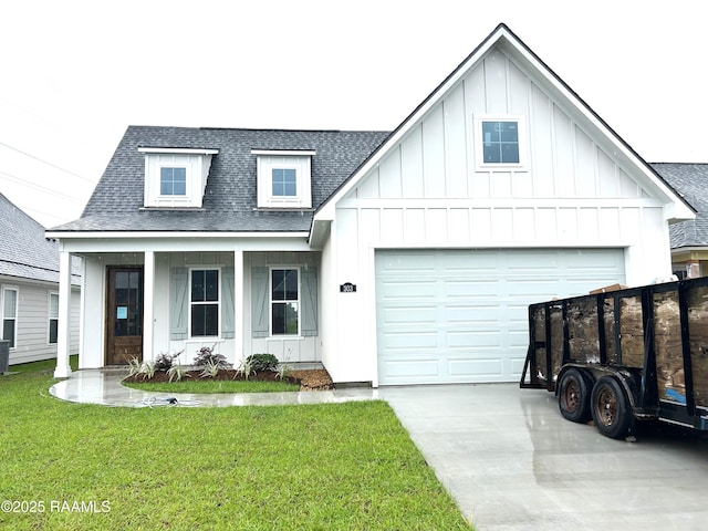 303 Bennington Ln, Youngsville, LA 70592 - modern farmhouse style home featuring a shingled roof, board and batten siding, concrete driveway, a front lawn, and an attached garage