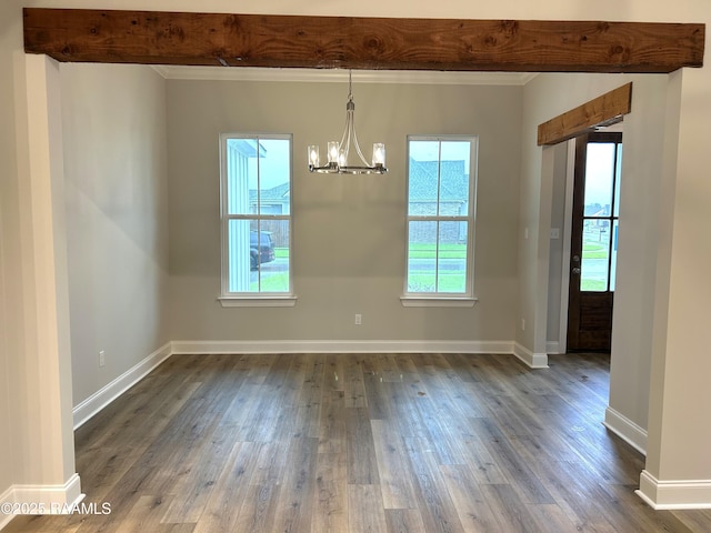 303 Bennington Ln, Youngsville, LA 70592 - unfurnished dining area with a chandelier, crown molding, dark wood-style flooring, and baseboards