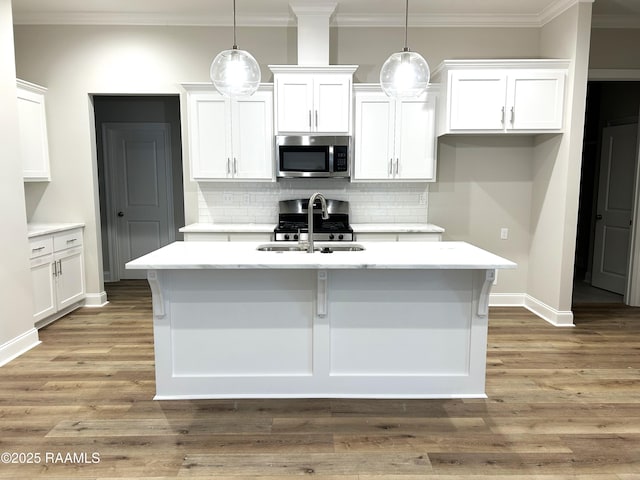 303 Bennington Ln, Youngsville, LA 70592 - kitchen with stainless steel microwave, white cabinetry, and crown molding