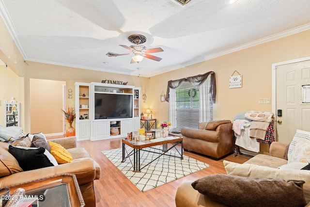 living room with wood finished floors, ceiling fan, and crown molding