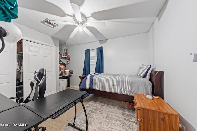 bedroom featuring a ceiling fan, a closet, concrete floors, and baseboards