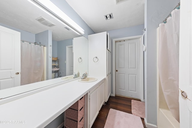 full bathroom with wood finished floors, vanity, and a shower with shower curtain