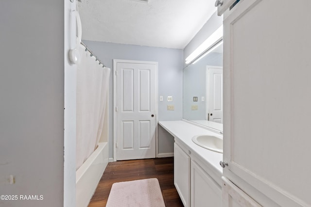 bathroom featuring wood finished floors, vanity, and a textured ceiling