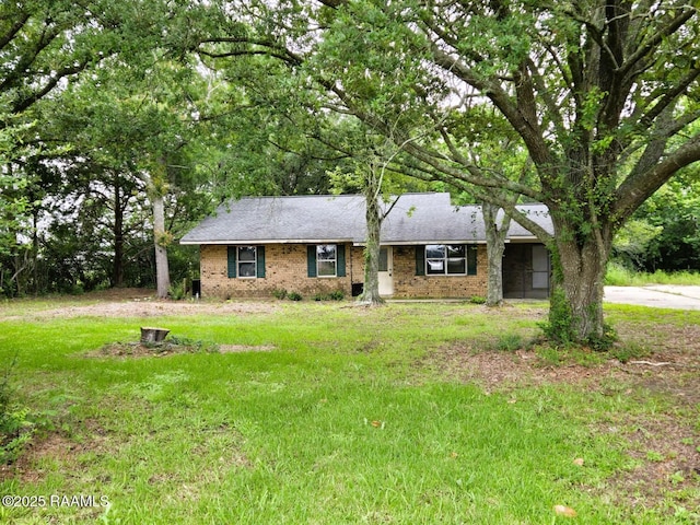 ranch-style house with brick siding and a front lawn