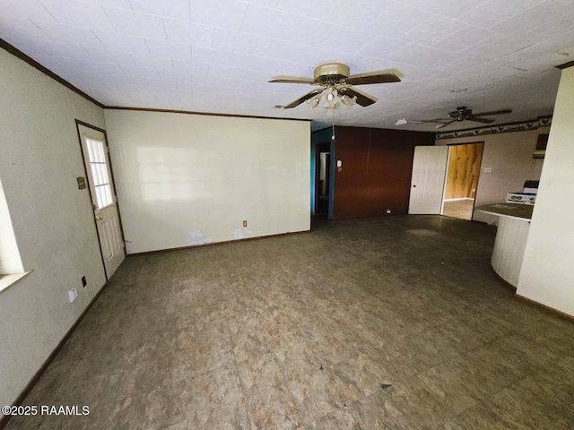 unfurnished living room with ornamental molding, baseboards, a ceiling fan, and tile patterned floors