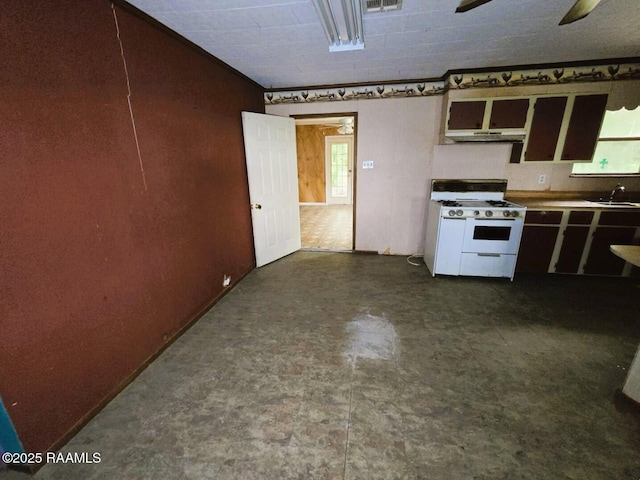 kitchen with white gas range oven, plenty of natural light, and a sink