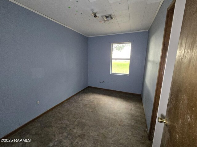 spare room with baseboards
